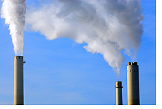 Image: many smoking industrial chimney stacks