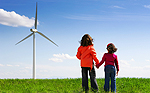 Image: young boy and girl by wind turbine